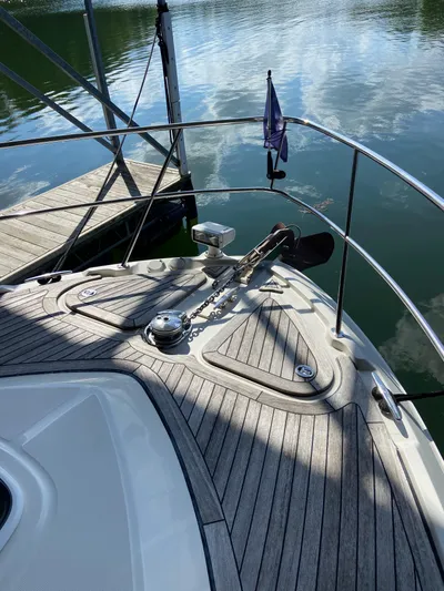Dream Chaser Yacht Photos Pics 2008 Sea Ray 47 Sedan Bridge bow with anchor, docked on calm water.