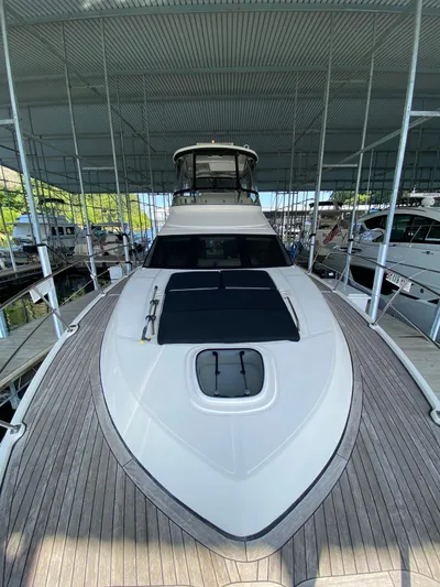 Dream Chaser Yacht Photos Pics 2008 Sea Ray 47 Sedan Bridge yacht docked under a covered marina.