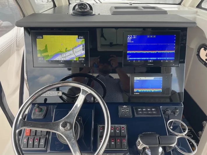  Yacht Photos Pics 2022 Pursuit S 328 Sport boat dashboard with navigation and control systems.