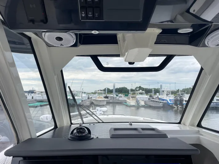  Yacht Photos Pics Interior view of 2022 Pursuit S 328 Sport boat at marina.