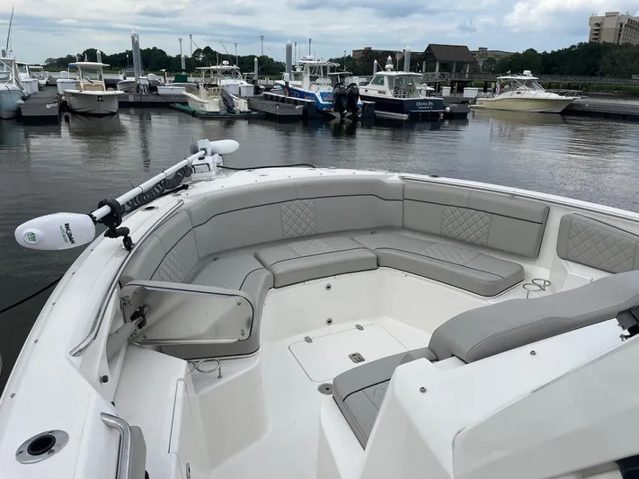  Yacht Photos Pics 2022 Pursuit S 328 Sport boat with spacious seating at a marina.