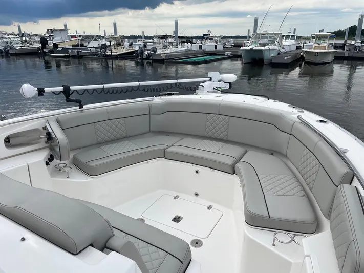  Yacht Photos Pics 2022 Pursuit S 328 Sport boat with spacious seating at a marina.