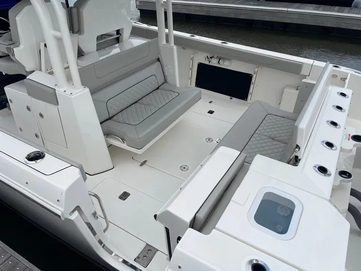  Yacht Photos Pics 2022 Pursuit S 328 Sport boat interior with seating and storage compartments.