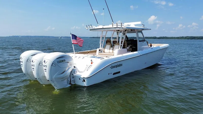  Yacht Photos Pics 2023 Everglades 395 Center Console boat with triple Yamaha engines on open water.