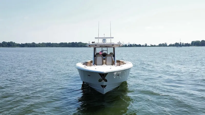  Yacht Photos Pics 2023 Everglades 395 Center Console boat on open water, front view.