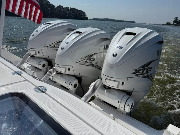  Yacht Photos Pics Triple Yamaha XTO Offshore engines on 2023 Everglades 395 Center Console boat, cruising on water.