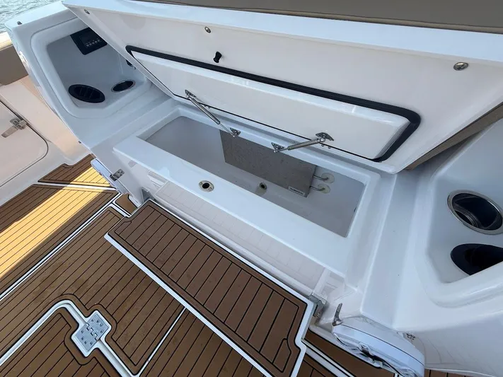  Yacht Photos Pics 2023 Everglades 395 Center Console boat with open storage compartment and teak flooring.