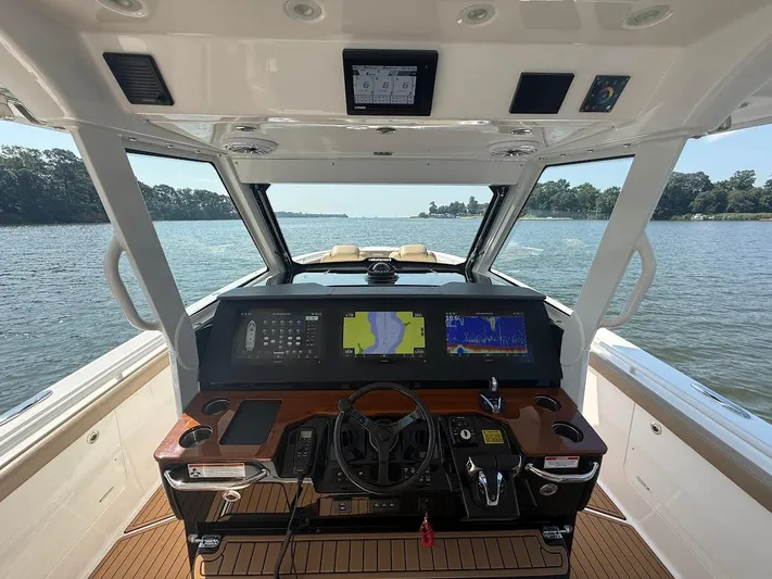  Yacht Photos Pics 2023 Everglades 395 Center Console boat interior with advanced navigation system on open water.