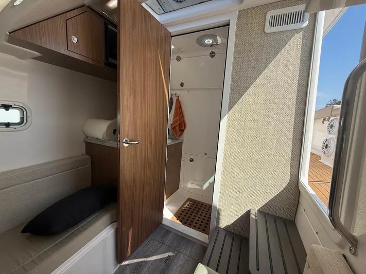  Yacht Photos Pics Interior of 2023 Everglades 395 Center Console boat with modern wood finish and seating.