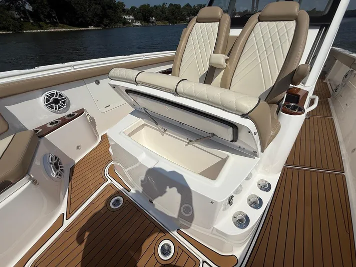  Yacht Photos Pics 2023 Everglades 395 Center Console boat interior with luxury seating and storage compartment.
