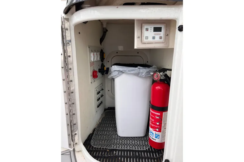 M/v Summer Wind Yacht Photos Pics 2018 Formula 350 Crossover Bowrider OB storage area with fire extinguisher and control panel.