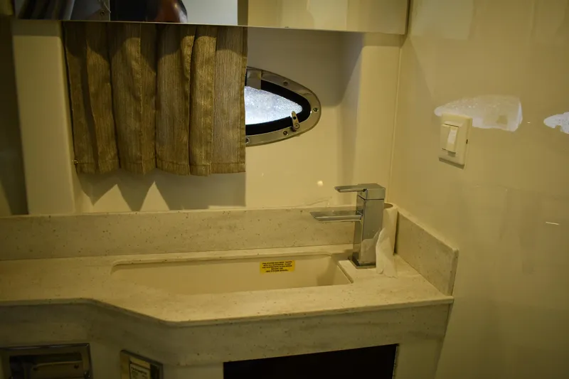 M/v Summer Wind Yacht Photos Pics 2018 Formula 350 Crossover Bowrider OB bathroom sink with modern faucet and porthole window.