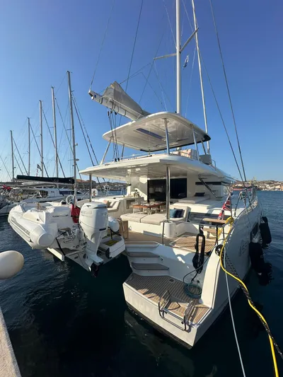  Yacht Photos Pics 2023 Lagoon 55 yacht docked at marina, showcasing sleek design and spacious deck.