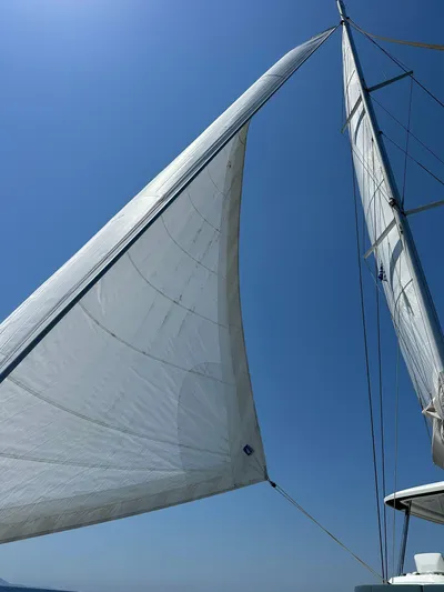  Yacht Photos Pics Sails of a 2023 Lagoon 55 yacht against a clear blue sky.