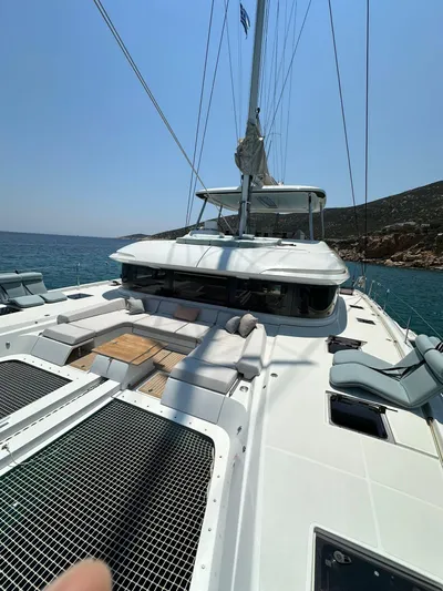  Yacht Photos Pics 2023 Lagoon 55 yacht on open water, featuring spacious deck and modern design.