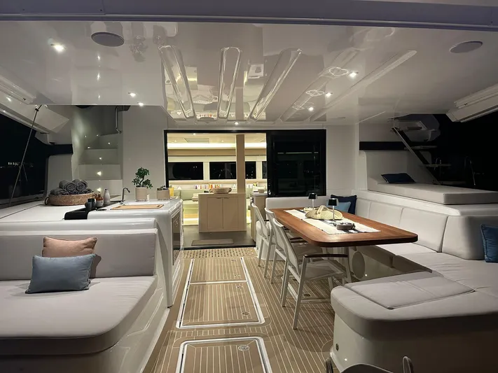  Yacht Photos Pics Luxurious interior of 2023 Lagoon 55 yacht with elegant seating and dining area.