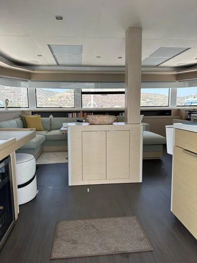  Yacht Photos Pics Luxurious interior of 2023 Lagoon 55 yacht with modern furnishings and panoramic windows.