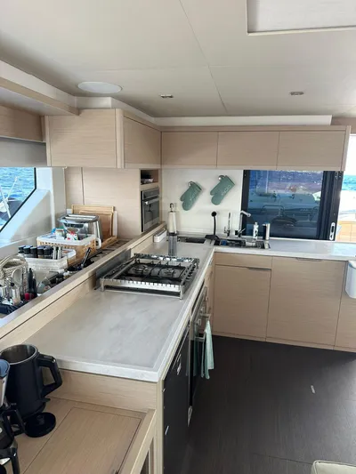  Yacht Photos Pics Modern kitchen interior on 2023 Lagoon 55 yacht with sleek cabinetry and appliances.