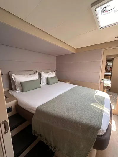  Yacht Photos Pics 2023 Lagoon 55 yacht bedroom with modern design, cozy bedding, and natural light.