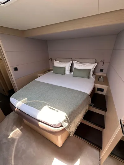  Yacht Photos Pics Luxurious bedroom interior of 2023 Lagoon 55 yacht with modern design and cozy bedding.