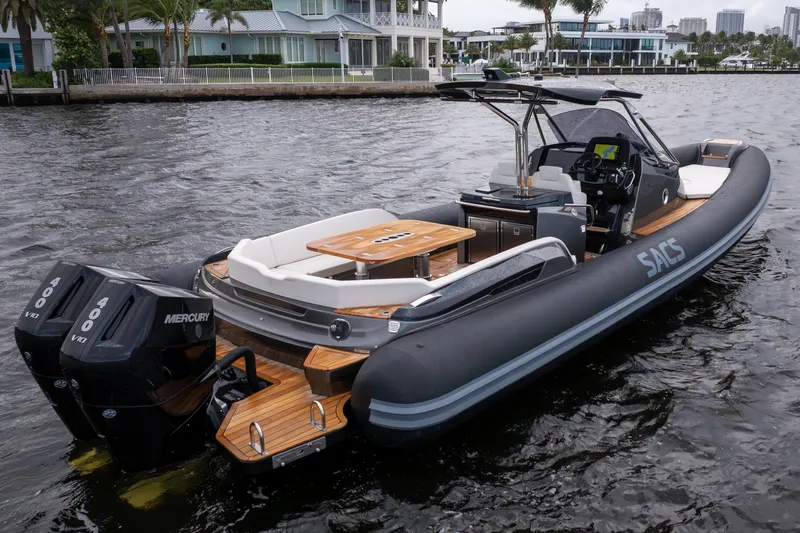 T/t Gypzy Yacht Photos Pics 2024 SACS Strider 11 luxury boat with dual Mercury engines on a scenic waterway.