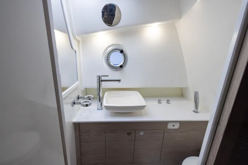 T/t Gypzy Yacht Photos Pics 2024 SACS Strider 11 yacht bathroom with modern sink and porthole window.