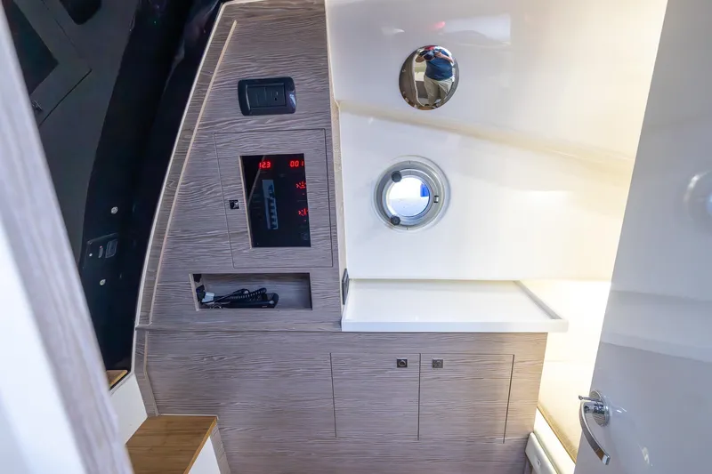 T/t Gypzy Yacht Photos Pics 2024 SACS Strider 11 interior cabin with control panel and porthole.