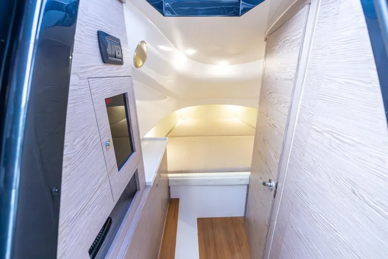 T/t Gypzy Yacht Photos Pics 2024 SACS Strider 11 cabin interior with modern wood paneling and cozy lighting.