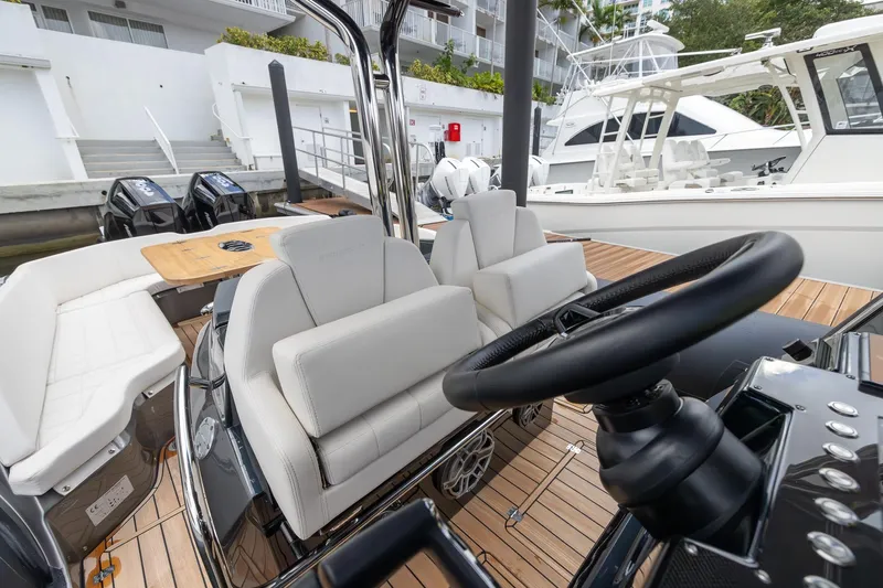 T/t Gypzy Yacht Photos Pics 2024 SACS Strider 11 luxury boat interior with modern seating and steering wheel.