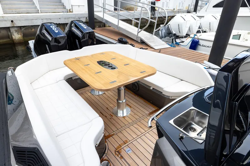 T/t Gypzy Yacht Photos Pics 2024 SACS Strider 11 yacht with elegant seating and wooden table on deck.