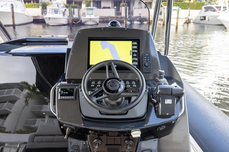 T/t Gypzy Yacht Photos Pics 2024 SACS Strider 11 boat dashboard with steering wheel and navigation display.