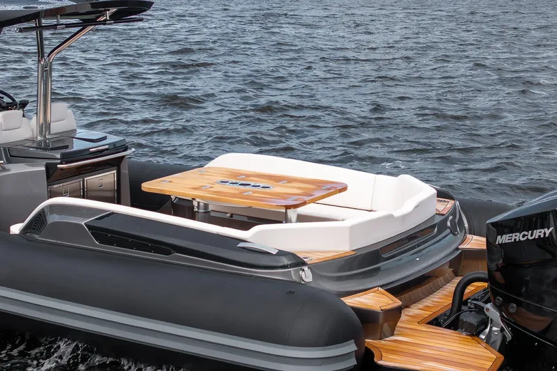 T/t Gypzy Yacht Photos Pics 2024 SACS Strider 11 luxury boat with teak deck and seating area on water.