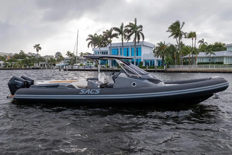 T/t Gypzy Yacht Photos Pics 2024 SACS Strider 11 boat on water, with modern design and palm trees in background.
