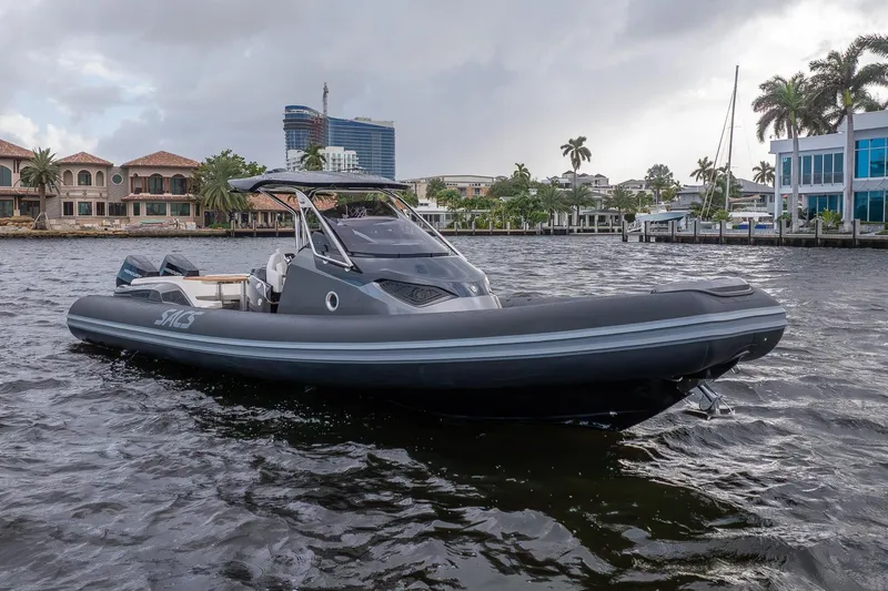 T/t Gypzy Yacht Photos Pics 2024 SACS Strider 11 luxury boat on water, modern design, waterfront homes in background.