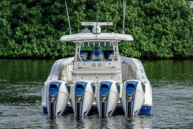  Yacht Photos Pics 2016 HCB 53 Sueños boat with five powerful outboard engines on a calm waterway.