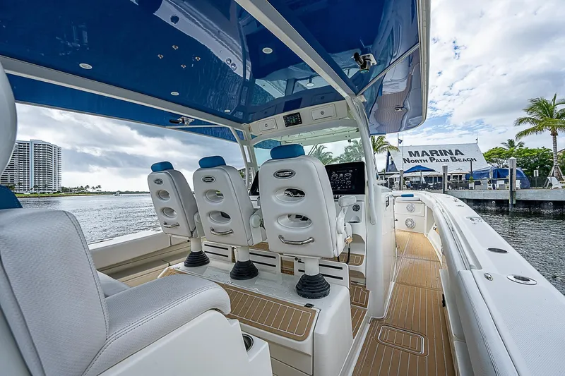  Yacht Photos Pics Interior view of 2016 HCB 53 Sueños boat with luxurious seating and helm.