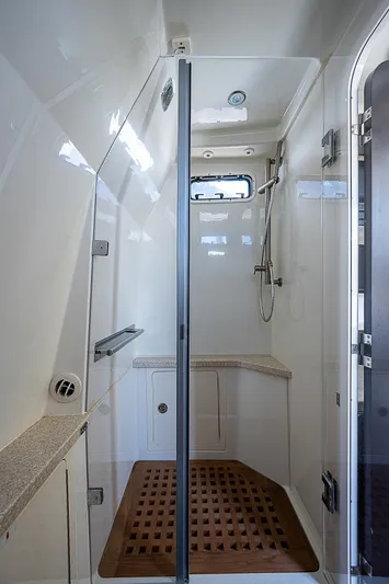  Yacht Photos Pics Luxurious shower area in 2016 HCB 53 Sueños boat with modern fixtures and wooden floor mat.