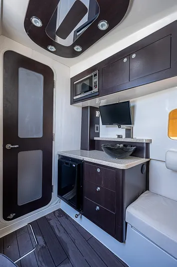  Yacht Photos Pics Interior of 2016 HCB 53 Sueños boat with modern kitchenette and seating area.