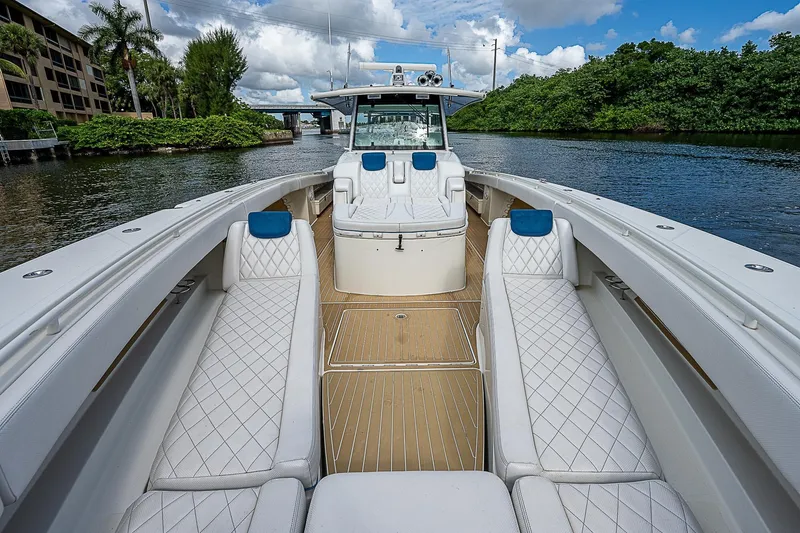  Yacht Photos Pics Luxurious 2016 HCB 53 Sueños yacht with elegant seating, cruising on a scenic waterway.