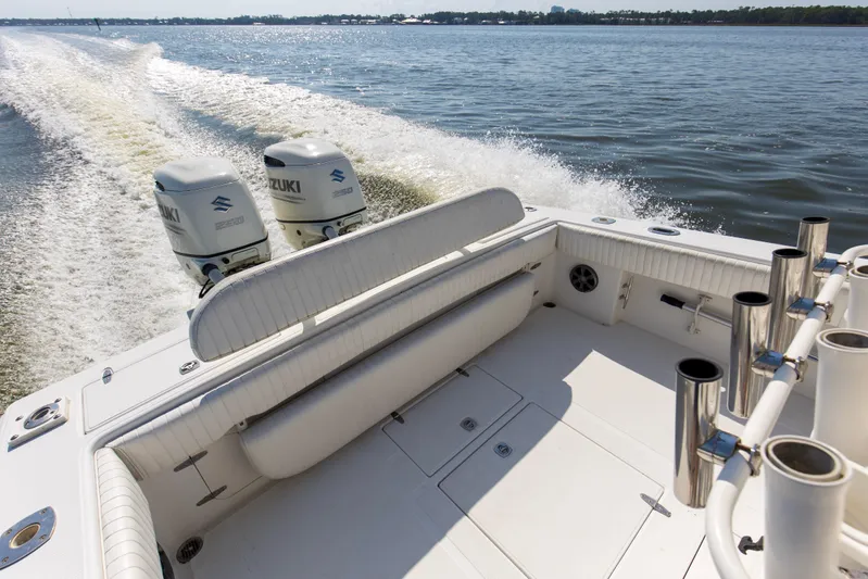Miss Millie II Yacht Photos Pics 2003 Jupiter 31 Open boat with dual Suzuki engines cruising on a calm lake.