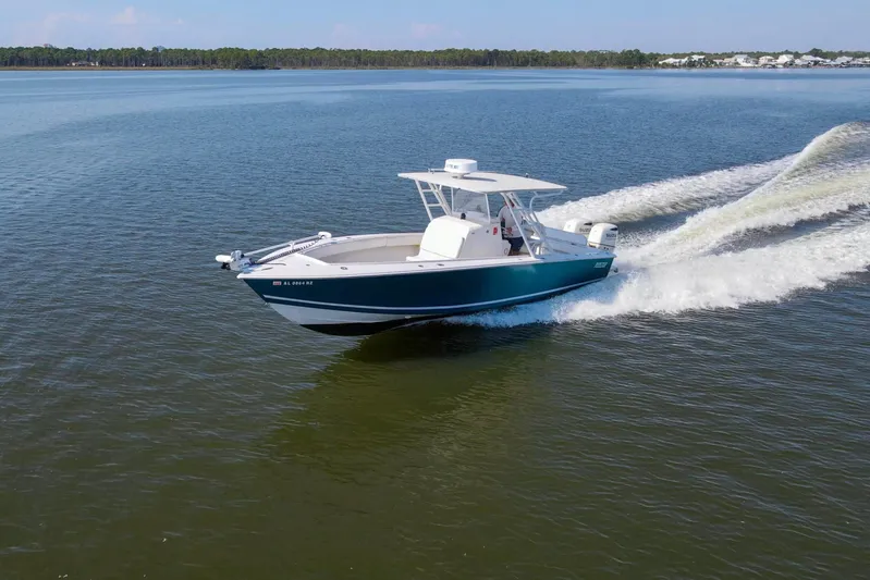 Miss Millie II Yacht Photos Pics 2003 Jupiter 31 Open boat cruising on a calm lake.