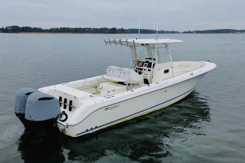  Yacht Photos Pics 2013 Edgewater 318CC boat on calm water, featuring twin engines and a sleek design.