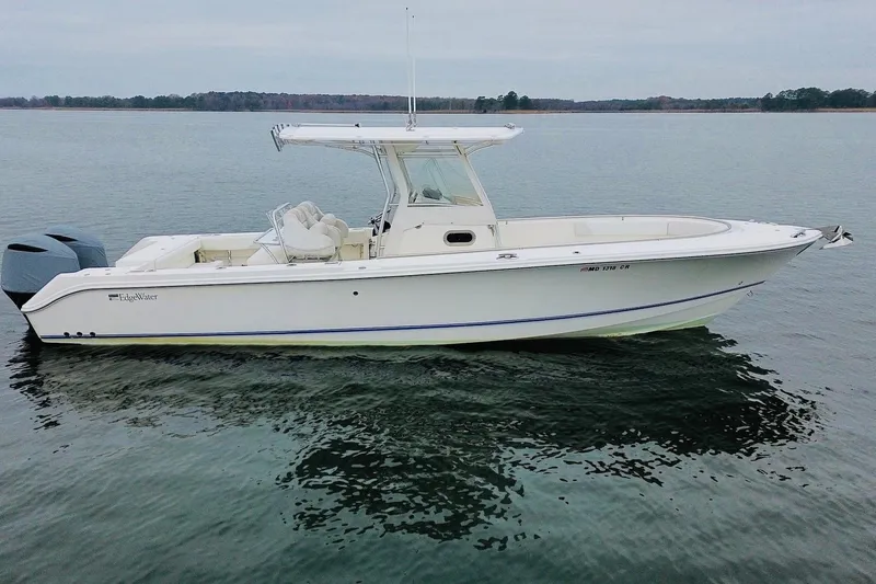  Yacht Photos Pics 2013 Edgewater 318CC boat on calm water, side view.