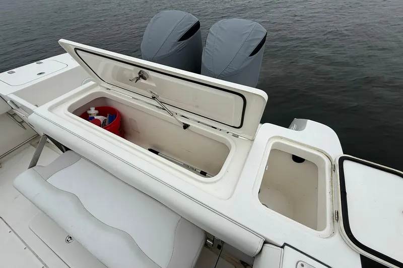  Yacht Photos Pics 2013 Edgewater 318CC boat with open storage compartments and covered engines.