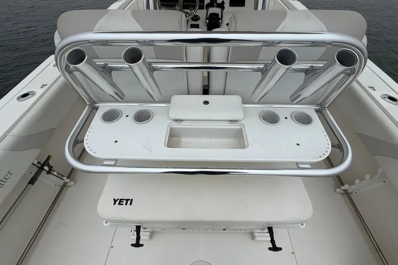  Yacht Photos Pics 2013 Edgewater 318CC boat with rod holders and YETI cooler on deck.