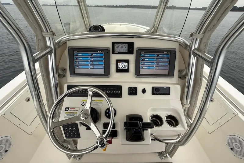  Yacht Photos Pics 2013 Edgewater 318CC boat dashboard with dual screens and steering wheel.