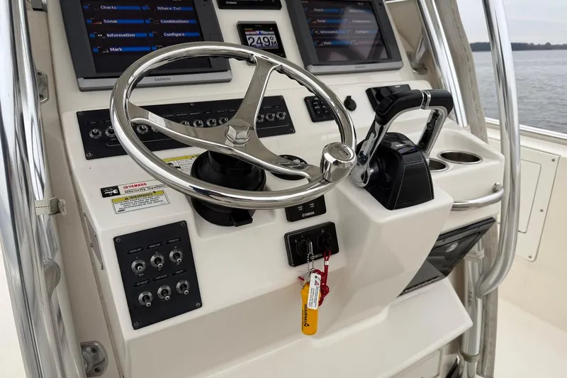  Yacht Photos Pics Edgewater 318CC 2013 boat console with steering wheel and navigation controls.