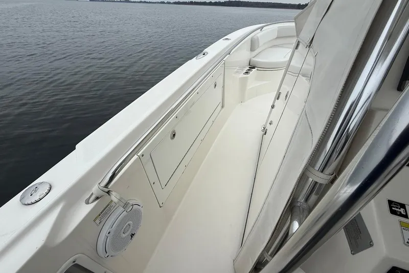 Yacht Photos Pics 2013 Edgewater 318CC boat interior with seating and storage, on calm water.