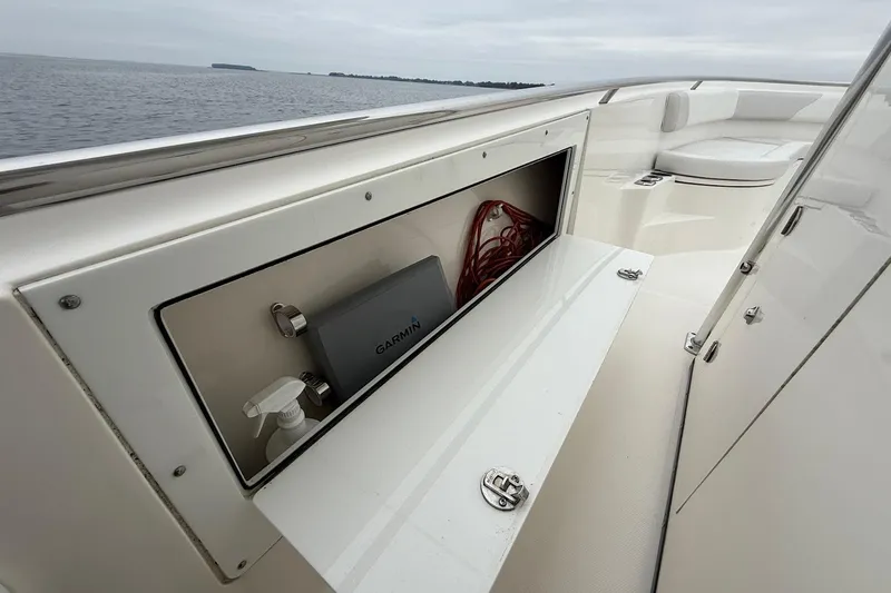  Yacht Photos Pics 2013 Edgewater 318CC boat interior with storage compartment and Garmin device.