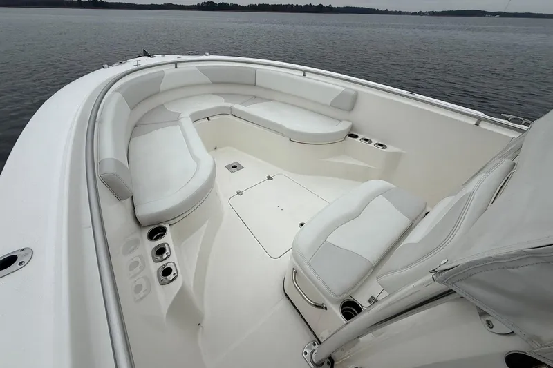  Yacht Photos Pics 2013 Edgewater 318CC boat interior with white seating and cup holders on calm water.